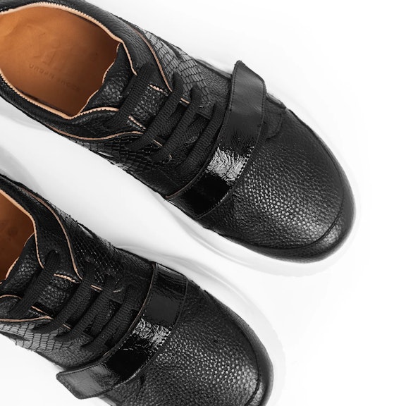 Sneakers Vitti Madrid. This sneaker is an epitome of urban sophistication with its sleek black leather construction. TexturThis sneaker is an epitome of urban sophistication with its sleek black leather construction. Textur...