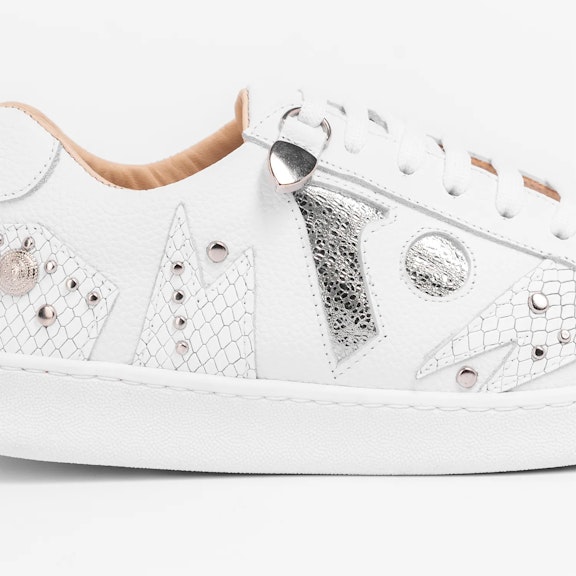 Sneakers Vitti Ibiza. White sneaker with tone-on-tone textured cutouts, silver studs, and the brand's logo in shiny silverWhite sneaker with tone-on-tone textured cutouts, silver studs, and the brand's logo in shiny silver...